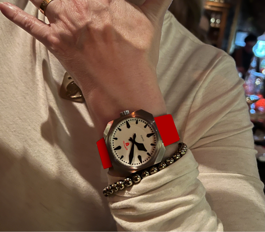 Normalzeit Die Comtess 36mm watch with red silicone strap worn on wrist, styled with silver jewelry