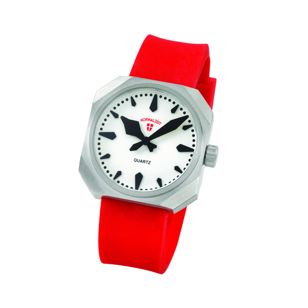 Normalzeit Red36 comes on a bright red, soft Silicone strap with a stainless steel buckle. Case is stainless steel with K-1 hardened crystal and full glow dial. Swiss Quartz movement and water resistant to 50m/5ATM.